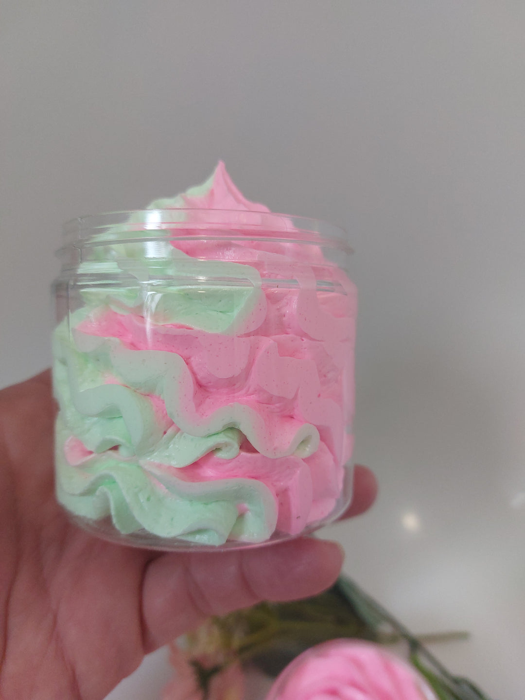 side view of whipped soap in green and pink in black cherry creamy texture by BubbleShop