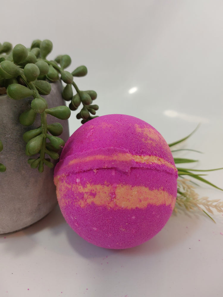 Fantasy perfume inspired bath bomb by BubbleShop with orange and pink colours and a sweet fruity fragrance