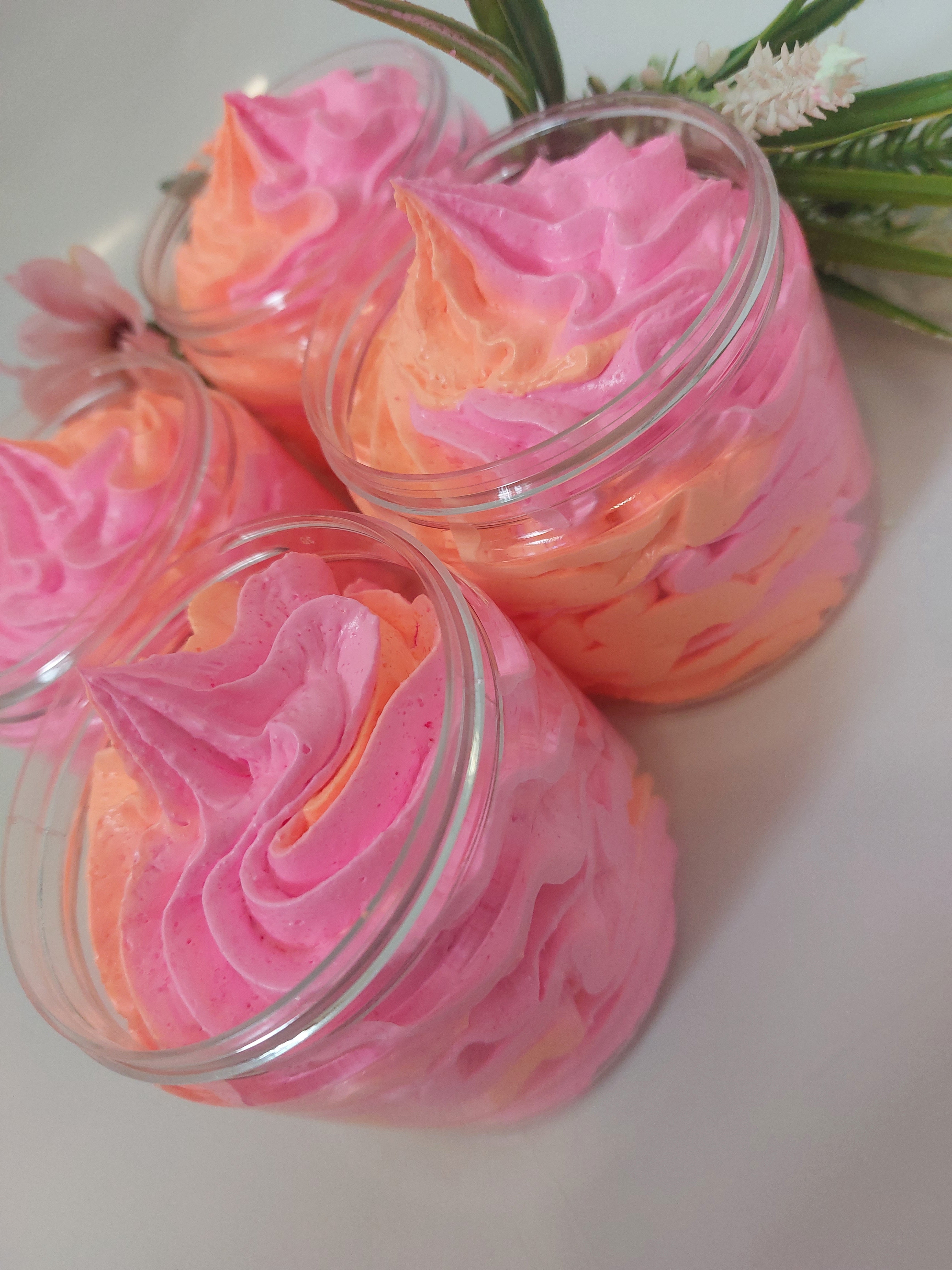 side photo of 4 whipped soap in pink and orange showing texture and piping by BubbleShop  in a perfume inspired fragrance  