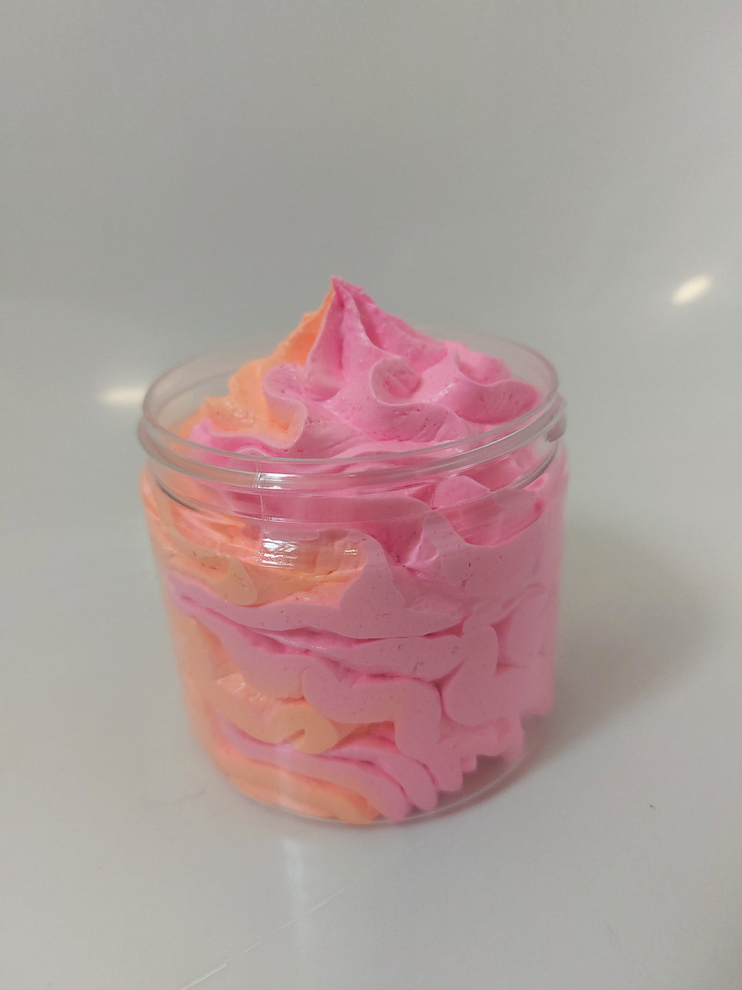 side photo of pink and orange whipped soap in 120 gram pot showing colours by BubbleShop in fantasy inspired fragrance 