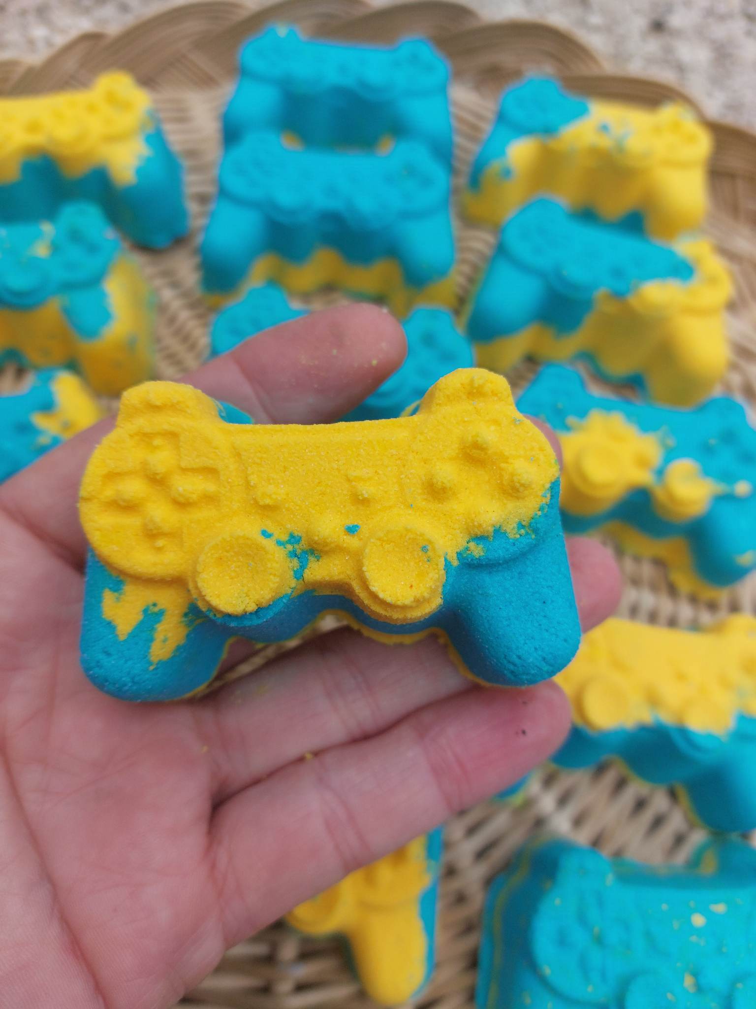 one yellow and blue  gamer bath bomb in a hand by BubbleShop