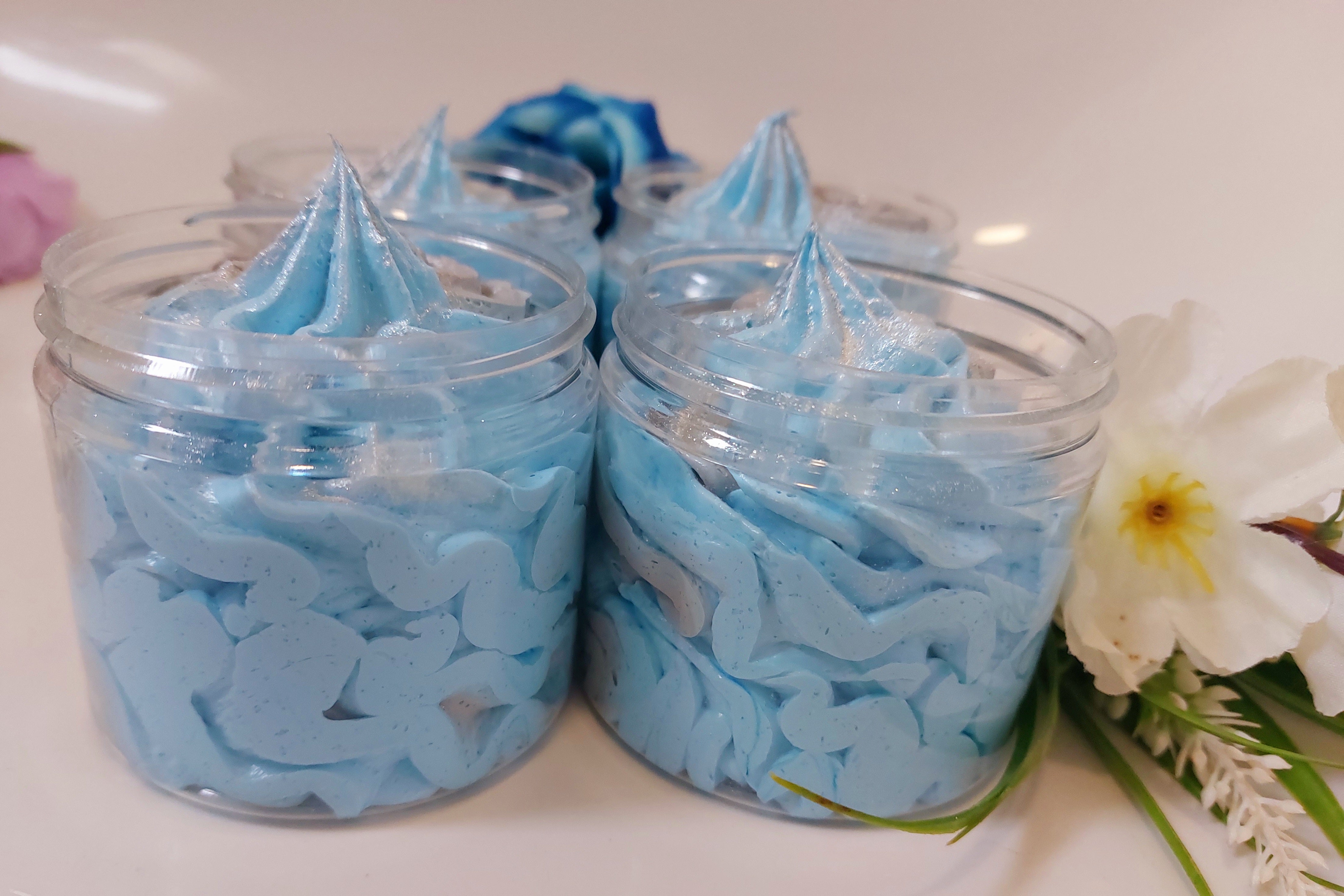 side photo of pots of blue and grey fluffy whipped soap in savage fragrance by bubbleshop